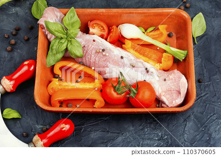 Raw uncooked meat tenderloin in a baking dish. 110370605