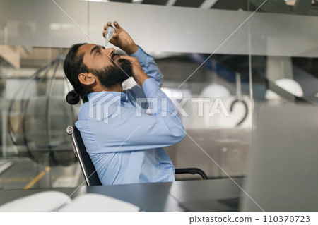 Businessman has severe eye pain, drips drops for pain relief Businessman has severe eye pain, drips drops for pain relief 110370723