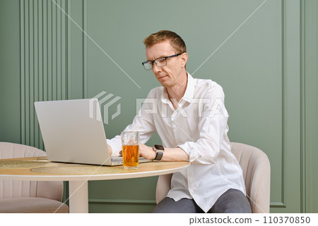 Middle aged man using laptop looking for an apartment 110370850
