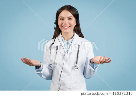 Smiling woman doctor with headset gesturing on blue Smiling woman doctor with headset gesturing on blue 110371313