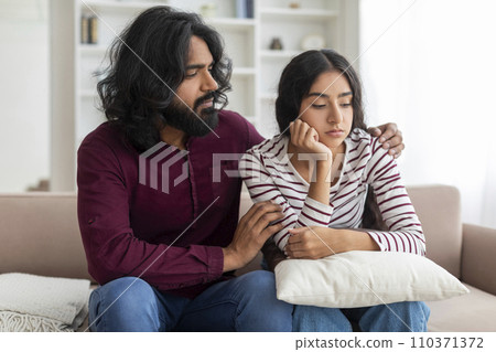 Supportive indian husband comforting his crying depressed wife 110371372