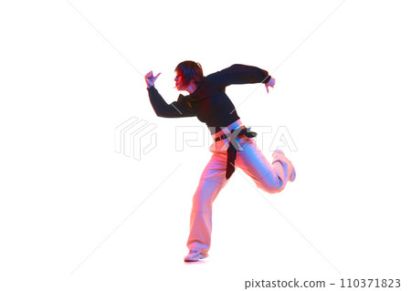 Active young girl in casual clothes dancing hip hop, dance hall isolated over white background in neon light Active young girl in casual clothes dancing hip hop, dance hall isolated over white background in neon light 110371823