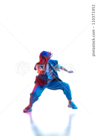 Hip hop, contemp, dance hall, street style dancer. Young girl in motion dancing isolated over white background in neon light 110371952