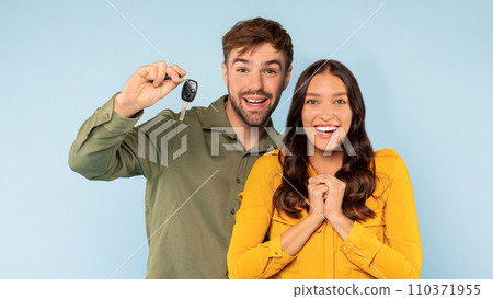 Joyful couple with new car keys on blue background Joyful couple with new car keys on blue background 110371955