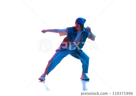 Young girl in sport style casual clothes dancing dace hall, hip hop isolated over white background in neon light Young girl in sport style casual clothes dancing dace hall, hip hop isolated over white background in neon light 110371998