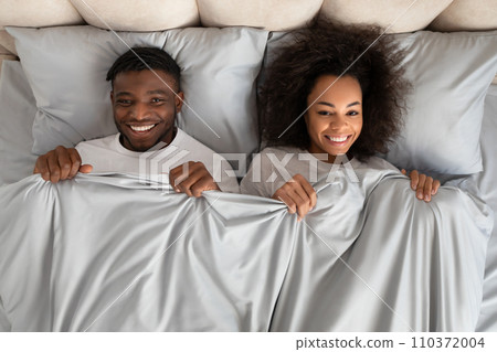 Top View African Couple Lying In Bed Covered With Blanket Top View African Couple Lying In Bed Covered With Blanket 110372004