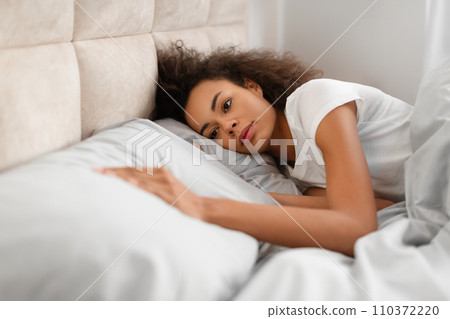 Frustrated Black Lady Touching Empty Pillow Lying In Bed Indoors Frustrated Black Lady Touching Empty Pillow Lying In Bed Indoors 110372220