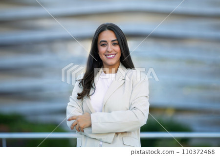 Portrait Of Confident Arabic Businesswoman Posing With Folded Arms Outside 110372468