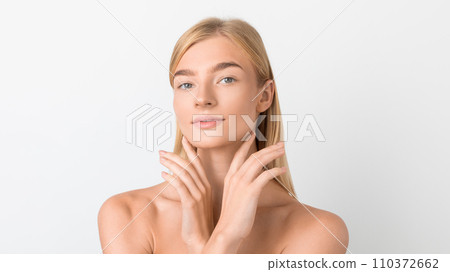 blonde lady posing holding hands near face over white backdrop blonde lady posing holding hands near face over white backdrop 110372662