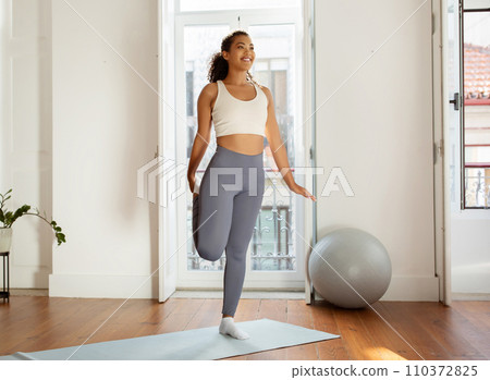 fitness lady making heel to butt exercise in living room fitness lady making heel to butt exercise in living room 110372825
