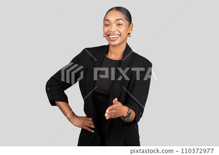 Engaging African American businesswoman extending a handshake with a bright 110372977