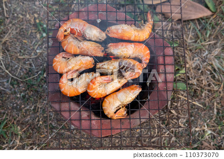 Grilled river prawns on a charcoal grill. Grilled river prawns on a charcoal grill. 110373070