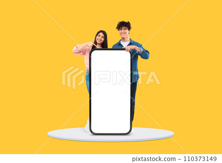 Cheerful young duo pointing at blank mobile screen Cheerful young duo pointing at blank mobile screen 110373149