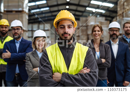 Full team of warehouse employees standing in warehouse. Team of workers, managers, female director in modern industrial factory, heavy industry, manufactrury. Full team of warehouse employees standing in warehouse. Team of workers, managers, female director in modern industrial factory, heavy industry, manufactrury. 110373175