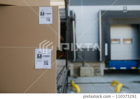 Close up of cardboard boxes, delivered goods in front of warehouse. Close up of cardboard boxes, delivered goods in front of warehouse. 110373291