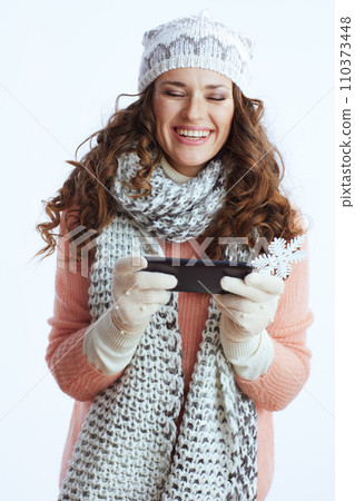 cheerful woman on sending text message using smartphone 110373448