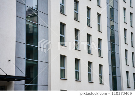 Detail of office building. Part of house facade. Business center exterior. Modern city architecture Detail of office building. Part of house facade. Business center exterior. Modern city architecture 110373469