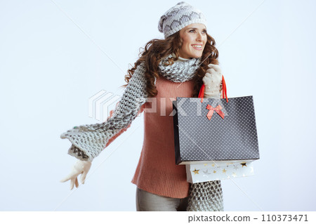 smiling 40 years old woman in sweater, mittens, hat and scarf smiling 40 years old woman in sweater, mittens, hat and scarf 110373471