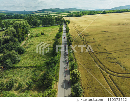 Top view of cycling races. Professional cyclists biking on the road. Top view of cycling races. Professional cyclists biking on the road. 110373512