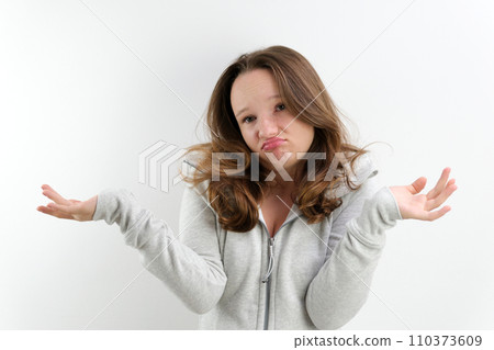 Puzzled young caucasian woman looks uncertain and confused, shrug shoulders in hesitation, spreading hands in obscurity over white background for your advertisment or promotional text Puzzled young caucasian woman looks uncertain and confused, shrug shoulders in hesitation, spreading hands in obscurity over white background for your advertisment or promotional text 110373609