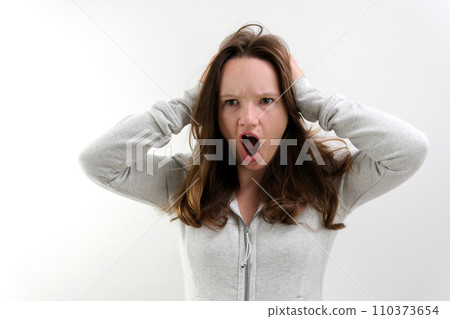 dissatisfied with working on the computer pressing buttons speaking evil young teenage girl opening her mouth waving her hand indignant bad task communication online negative emotions indignation 110373654