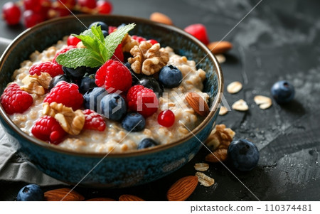 Close-up of a bowl of oatmeal with berries and nuts. 110374481