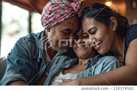 A family embracing, offering support to a member battling cancer, symbolizing love and care. World Cancer Day 110374502