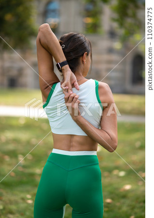 Smiling woman stretching her arms and looking contented Smiling woman stretching her arms and looking contented 110374775