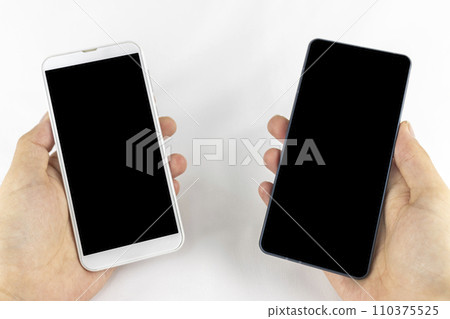 Hand of a man changing smartphone model Hand of a man changing smartphone model 110375525