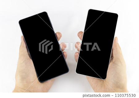 Hand of a man changing smartphone model 110375530