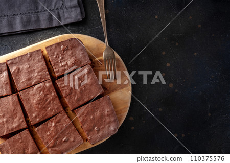 Chocolate brownie, simple coffee cake, overhead flat lay view on black 110375576