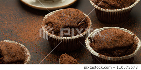 Chocolate and cocoa browny muffins with coffee cappuccino in cup angle view on brown rustic stone background, sweet homemade dark chocolate cupcakes 110375578