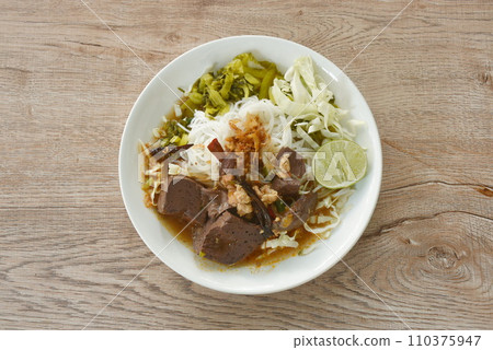 rice noodles fresh pickled and fresh cabbage eat with spicy chop pork and blood couple red cotton tree in curry sauce on plate rice noodles fresh pickled and fresh cabbage eat with spicy chop pork and blood couple red cotton tree in curry sauce on plate 110375947