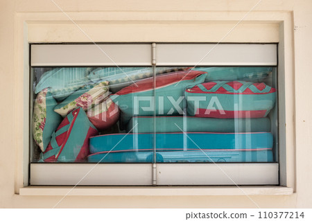 Closed window full of colorful pillows 110377214