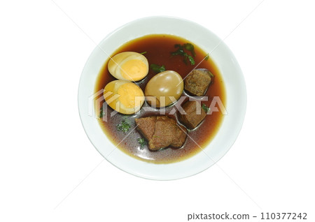 boiled half cut egg with tofu and pork in herb brown soup on plate 110377242