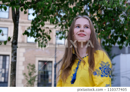 Beautiful young blonde girl in red blouse. Street fashion look. Pretty romantic woman portrait. 110377405