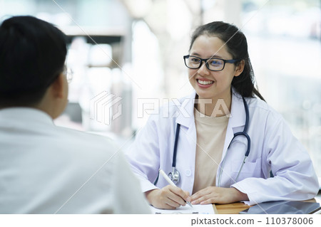Doctor talking to a patient at medical clinic.. Doctor talking to a patient at medical clinic.. 110378006