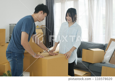 Young married couple moving into new home. Young married couple moving into new home. 110378020