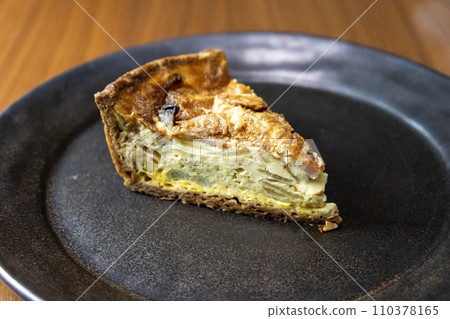 Broccoli and bacon quiche on a black plate 110378165