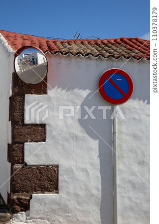 White wall with No standing traffic sign and a mirror White wall with No standing traffic sign and a mirror 110378179
