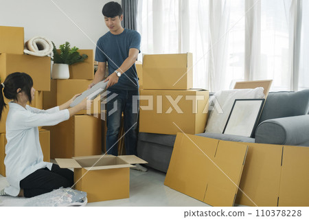 Young married couple moving into new home. Young married couple moving into new home. 110378228
