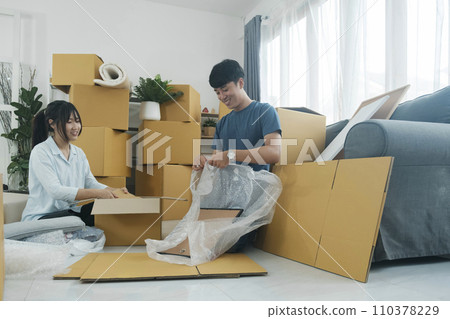 Young married couple moving into new home. 110378229
