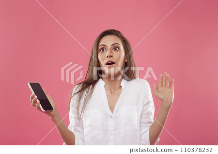 portrait of surprised girl with phone. Scared girl portrait of surprised girl with phone. Scared girl 110378232