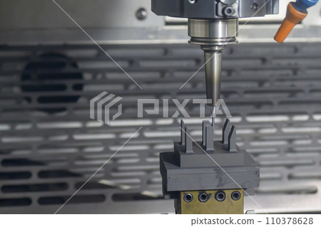 The CNC milling machine cutting the graphite electrode parts. The CNC milling machine cutting the graphite electrode parts. 110378628
