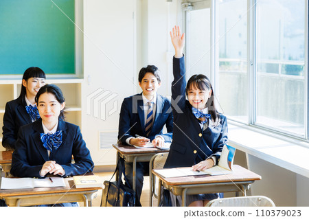 High school girl raising her hand in the classroom High school girl raising her hand in the classroom 110379023