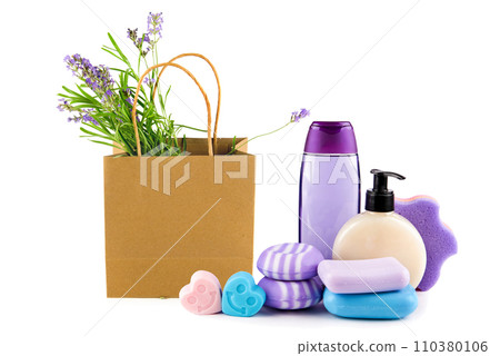 Lavender shampoo (shower gel), soap and a bouquet of lavender flowers in a paper bag isolated on a white . Collage. 110380106