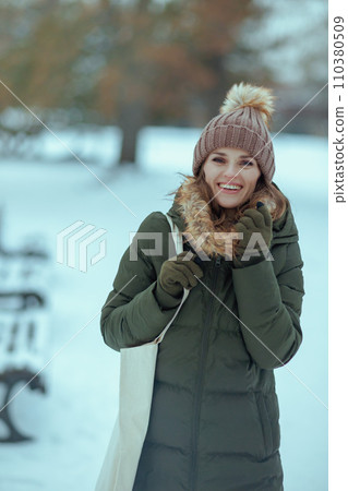 happy modern woman outdoors in city park in winter happy modern woman outdoors in city park in winter 110380509