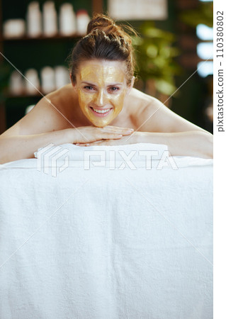 relaxed modern woman in massage cabinet laying on massage table 110380802