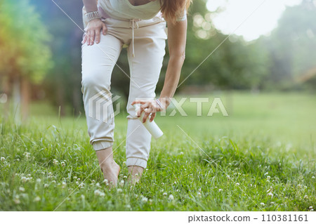 Closeup on woman in white shirt using repellent spray Closeup on woman in white shirt using repellent spray 110381161