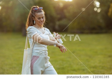 happy trendy female in white shirt using mites spray happy trendy female in white shirt using mites spray 110381165